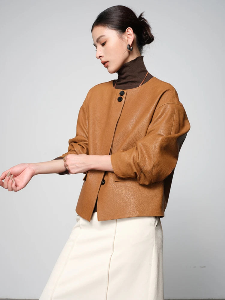 Ginger-brown leather short jacket with stand collar, snap buttons, and side pockets