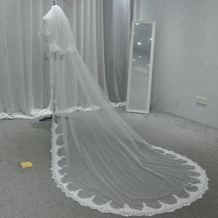 Floor-length bridal veil in sheer tulle with lace-trim border