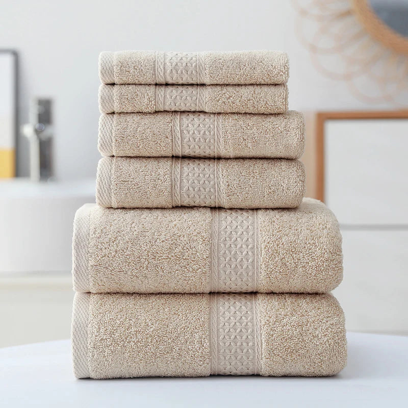 Light grey organic cotton towel set, 3-pc stack with textured borders and patterned center panels