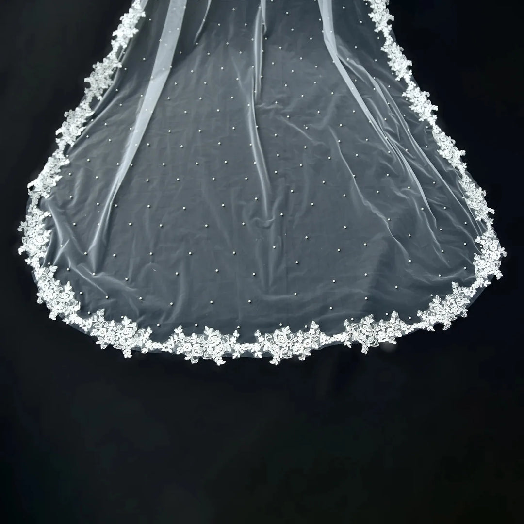 White sheer bridal cape hem with scalloped floral lace edge and pearl-like beading