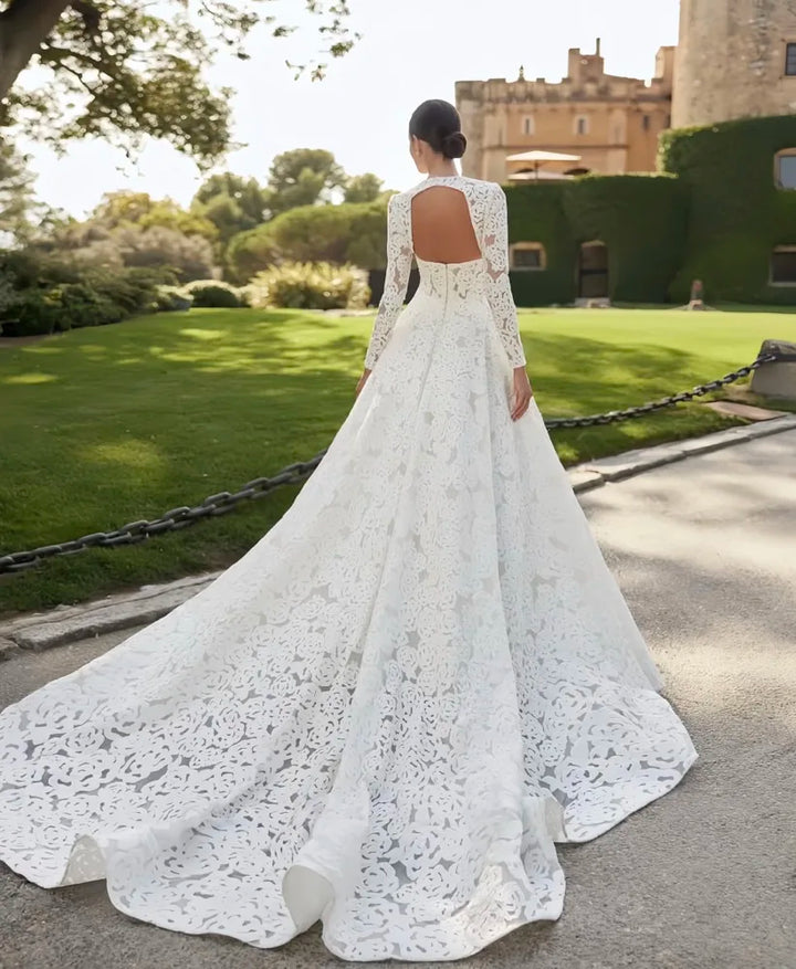 White lace bridal gown back view with open lace back and wide flowing skirt