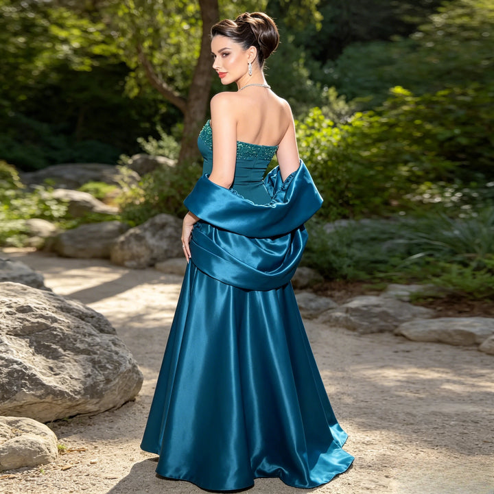Teal satin ball gown back view with beaded bodice and draped cape sleeves