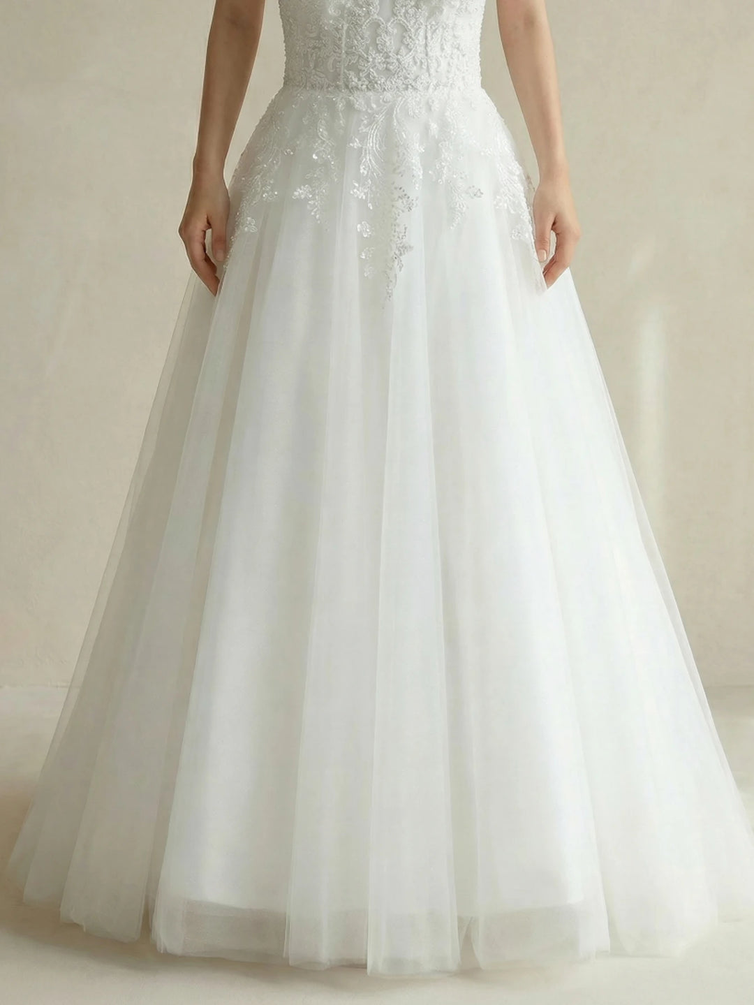White beaded bridal gown skirt with gathered tulle layers and soft, full flare