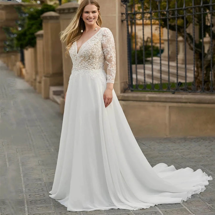 Ivory chiffon bridal gown with lace illusion sleeves, V-back, and flowing A-line skirt