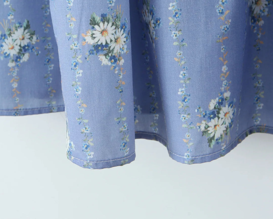 Blue daisy-print midi sundress hem with softly flared skirt