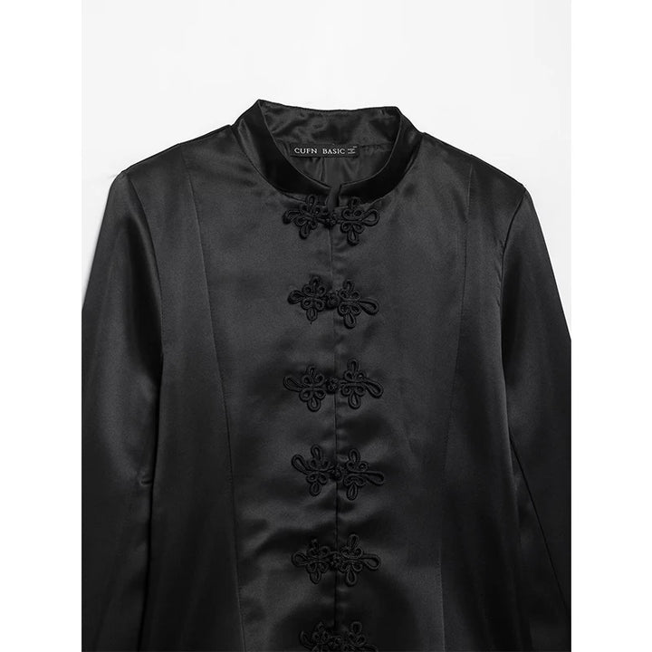 Black satin stand-collar blazer close-up with embroidered floral button placket