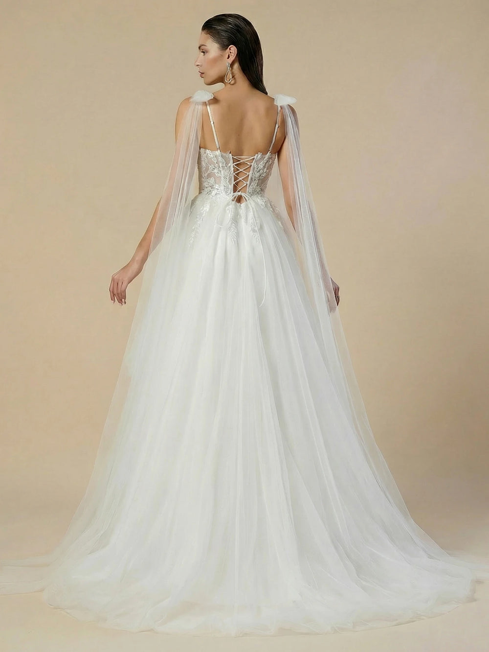 White wedding dress with sheer back cape and lace corset-style bodice