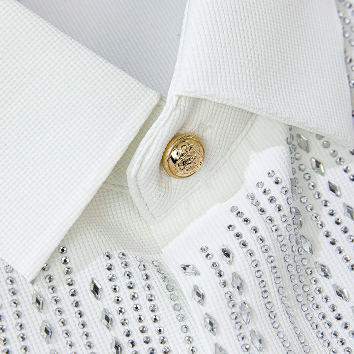White dress shirt detail: gold snap button and rhinestone-studded chest design
