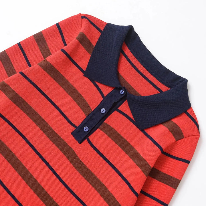 Close-up of orange-red striped polo sweater with navy collar and button placket