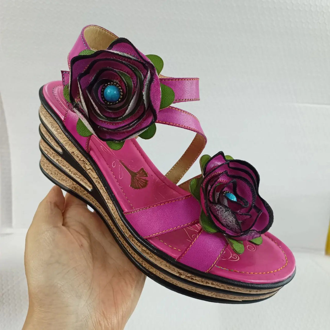 Rosy red leather wedge sandal with floral appliqués and black layered sole