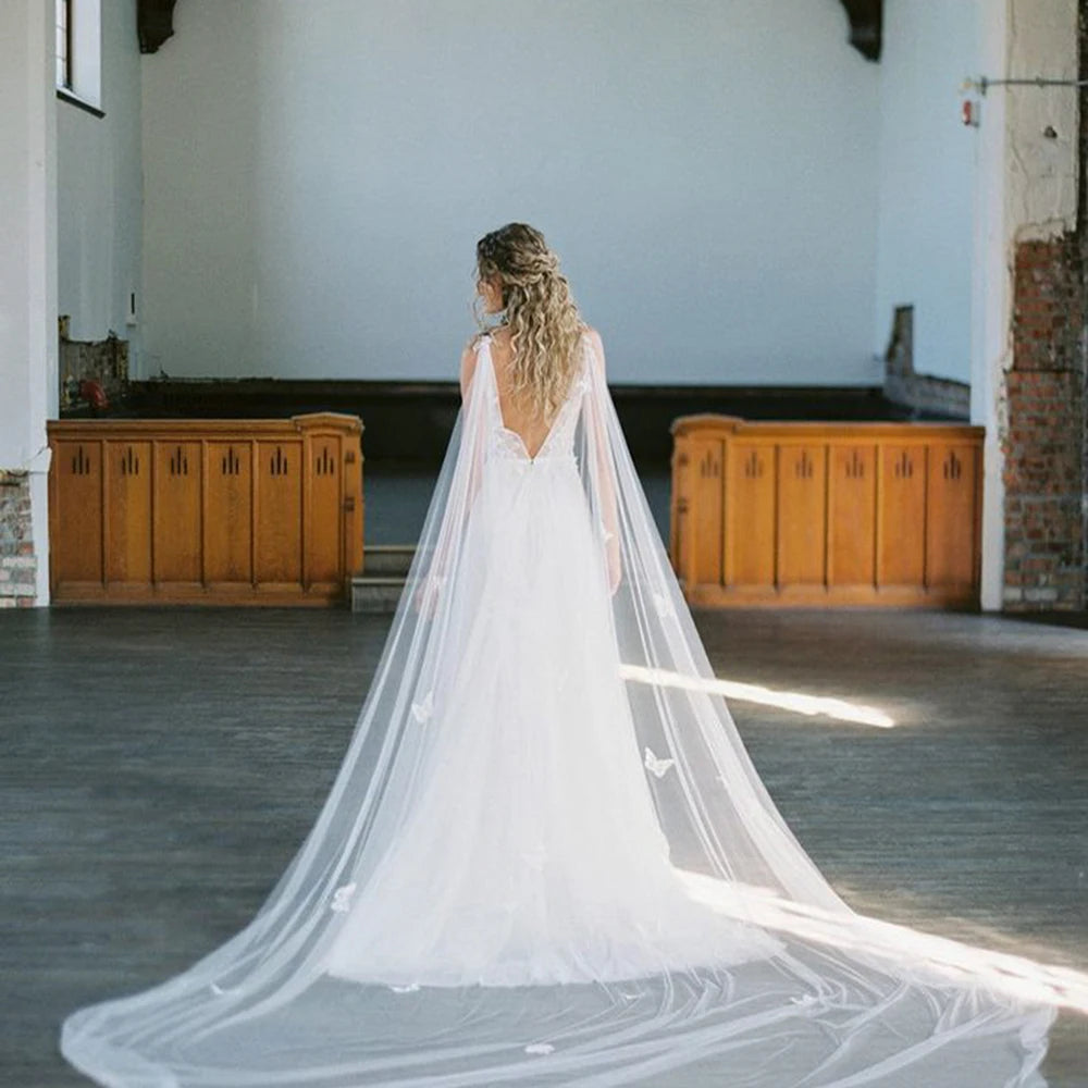 Off-white tulle bridal cape with 3D butterfly appliques, long flowing veil back