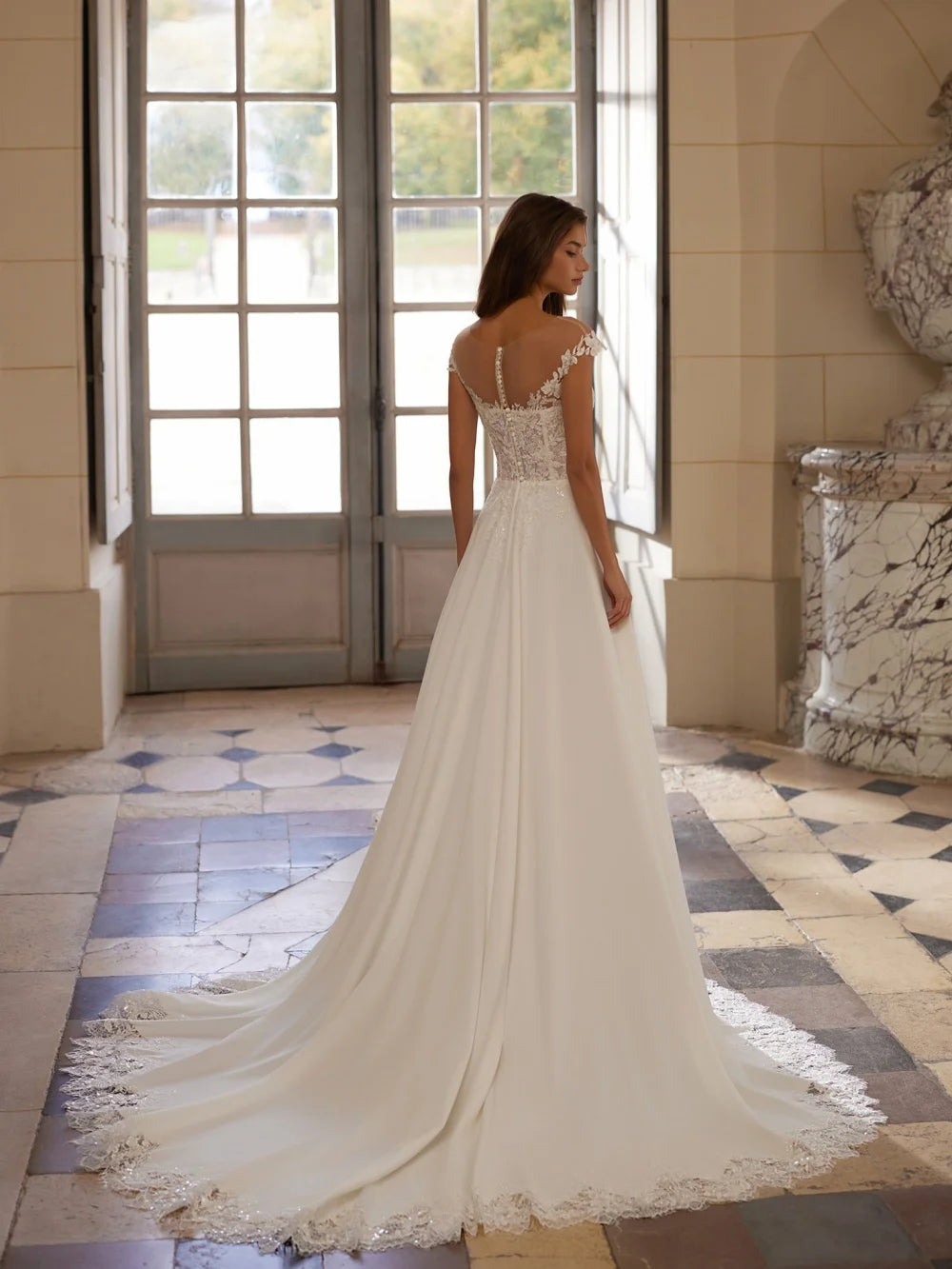 Ivory wedding dress with lace back and long flowing skirt with delicate hem trim