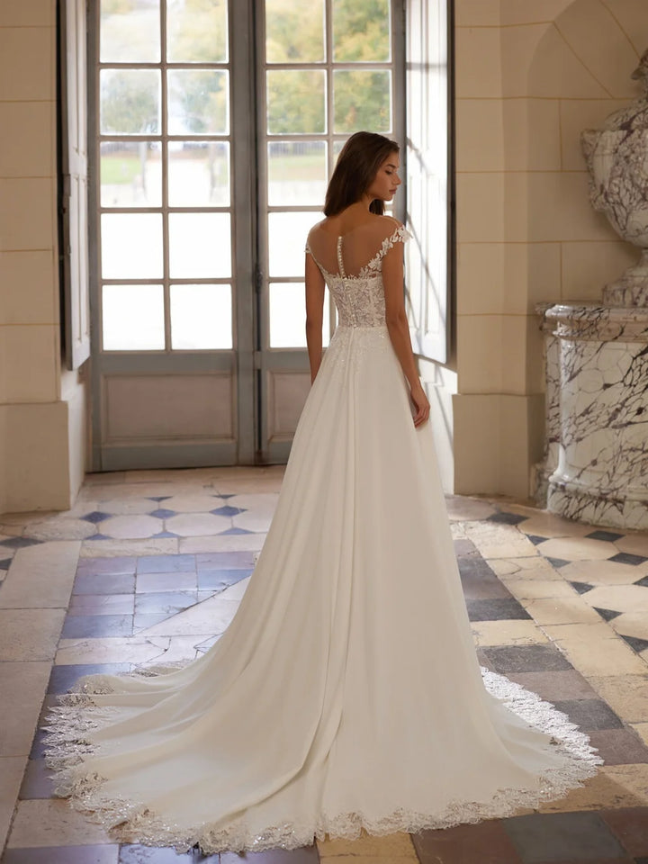 Ivory wedding dress with lace back and long flowing skirt with delicate hem trim