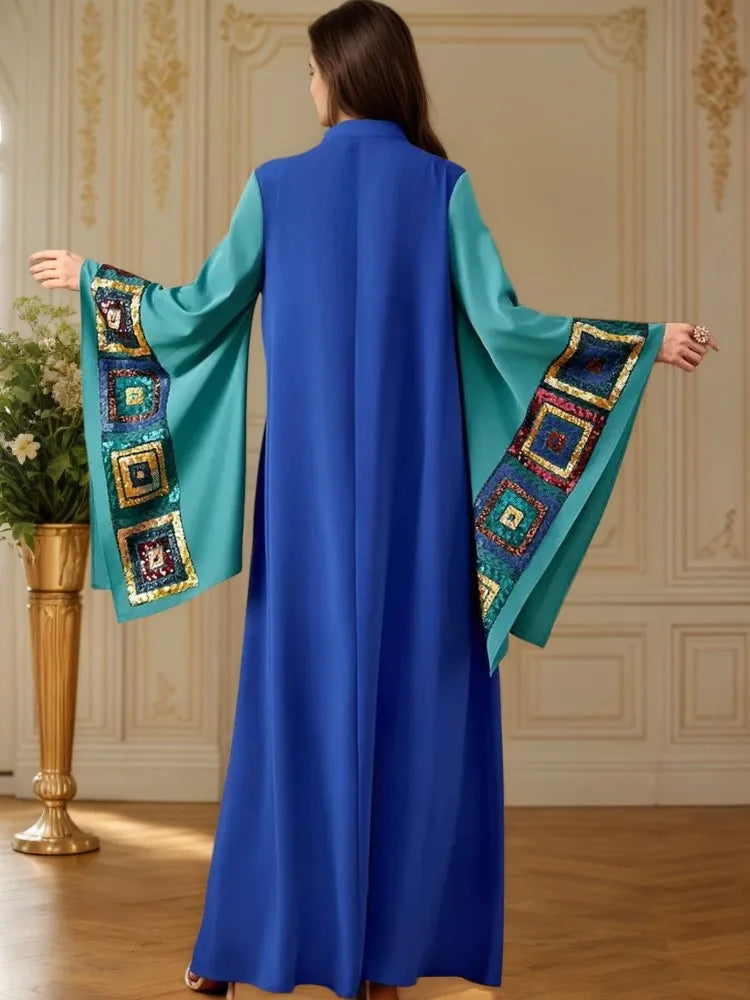 Back view: blue abaya dress with batwing sleeves and turquoise embroidered sleeve borders