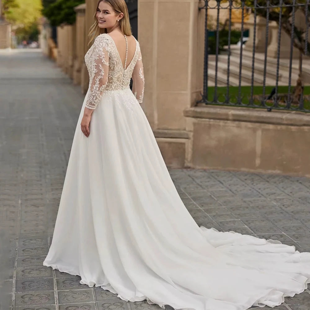 Ivory chiffon bridal gown with lace sleeves, open back, and flowing A-line skirt