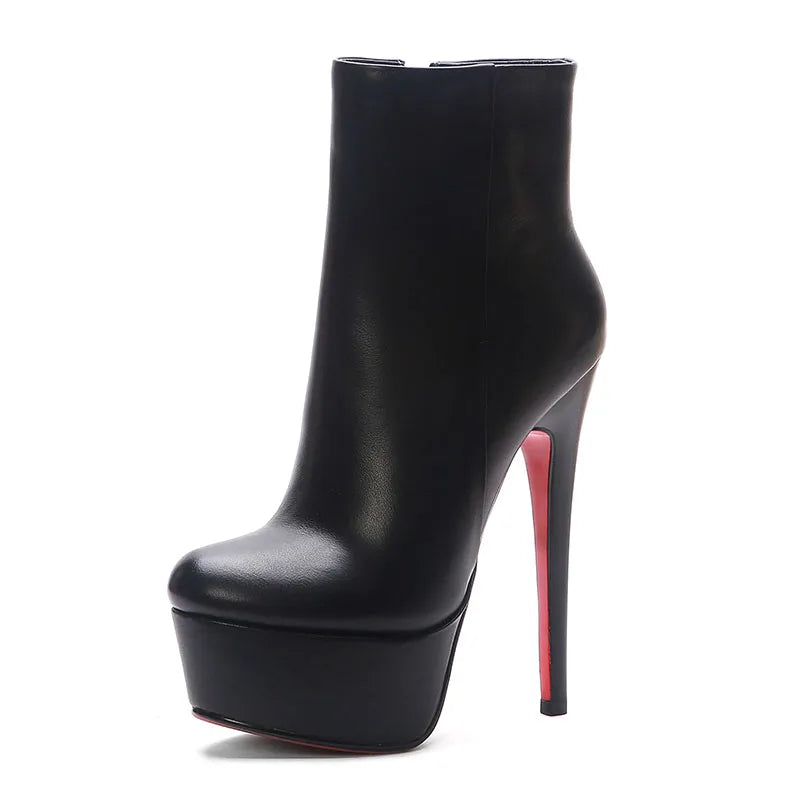 Black platform ankle boots with side zipper and tall stiletto heel.