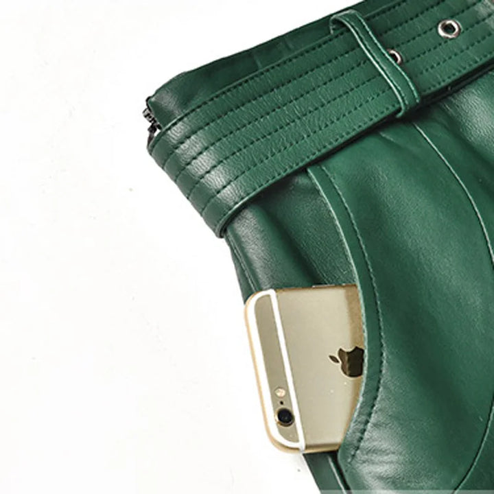 Green leather skirt waistband close-up with belt buckle and eyelets