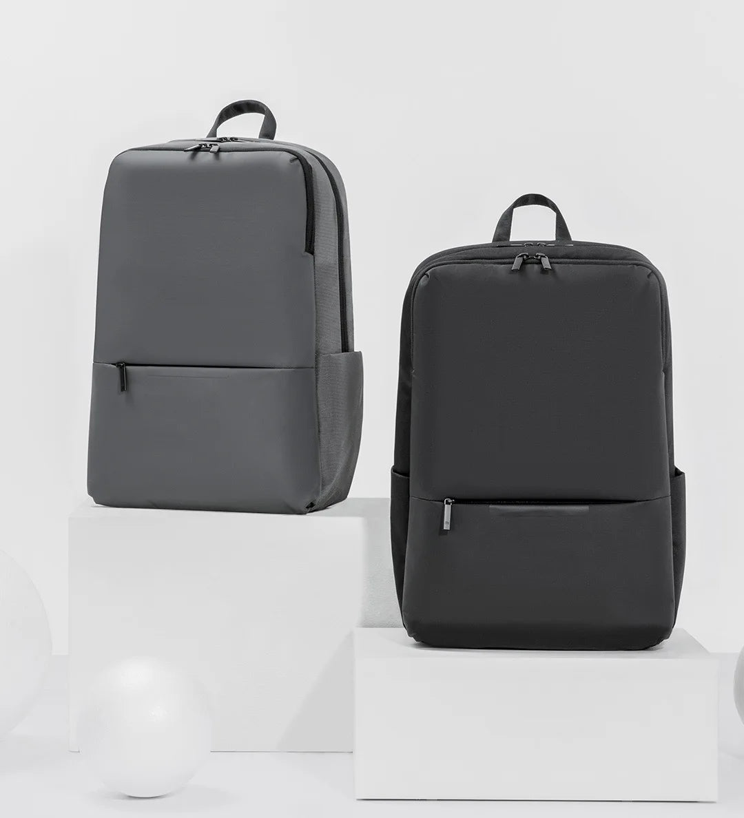 Gray and black travel work backpacks, front view side-by-side
