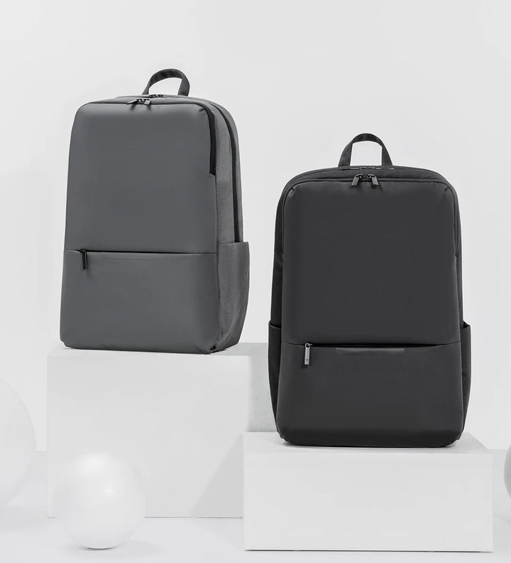 Gray and black travel work backpacks, front view side-by-side
