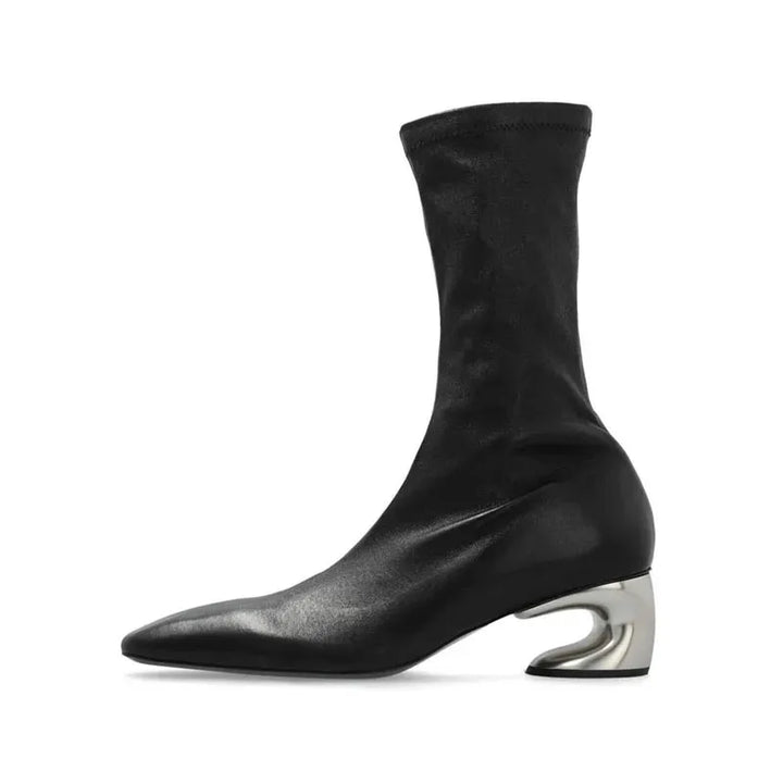 Black square-toe ankle boot with mid block heel and curved cutout detail, side profile