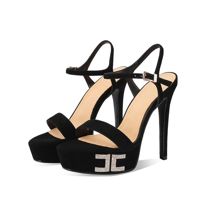 Black suede platform heeled sandals with crisscross straps and metal buckle