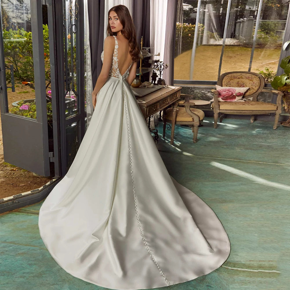 White bridal gown with lace bodice, cap-sleeve straps, and side slit in flowing skirt