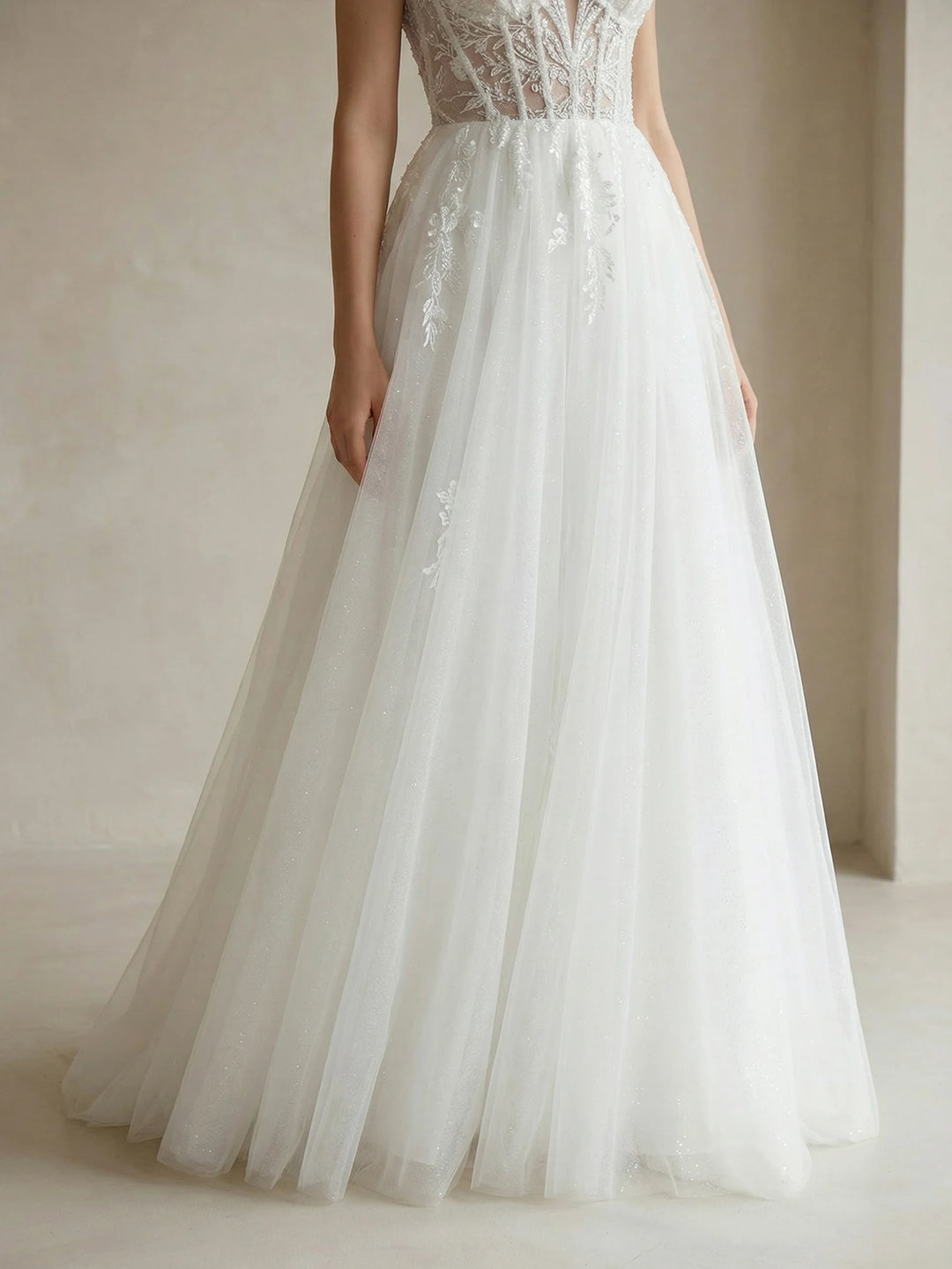 White bridal gown with embroidered corset bodice and layered tulle skirt with full volume