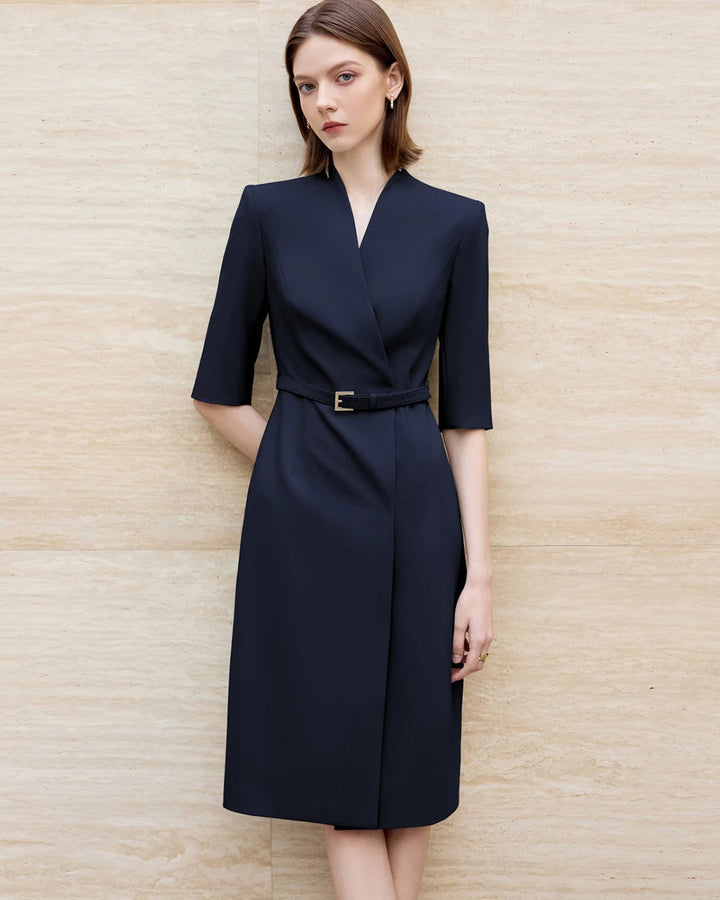 Front view of navy knee-length skirt suit dress with V-neck and waist belt