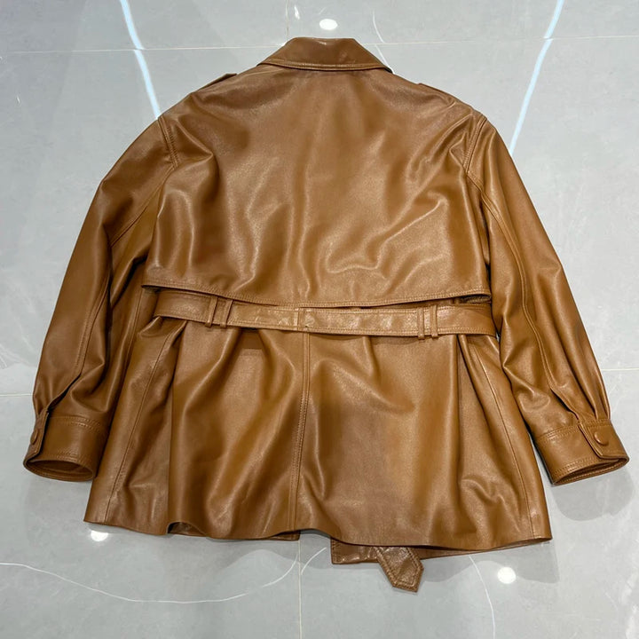 Back view of belted tan-brown leather coat with point collar and snap button closure