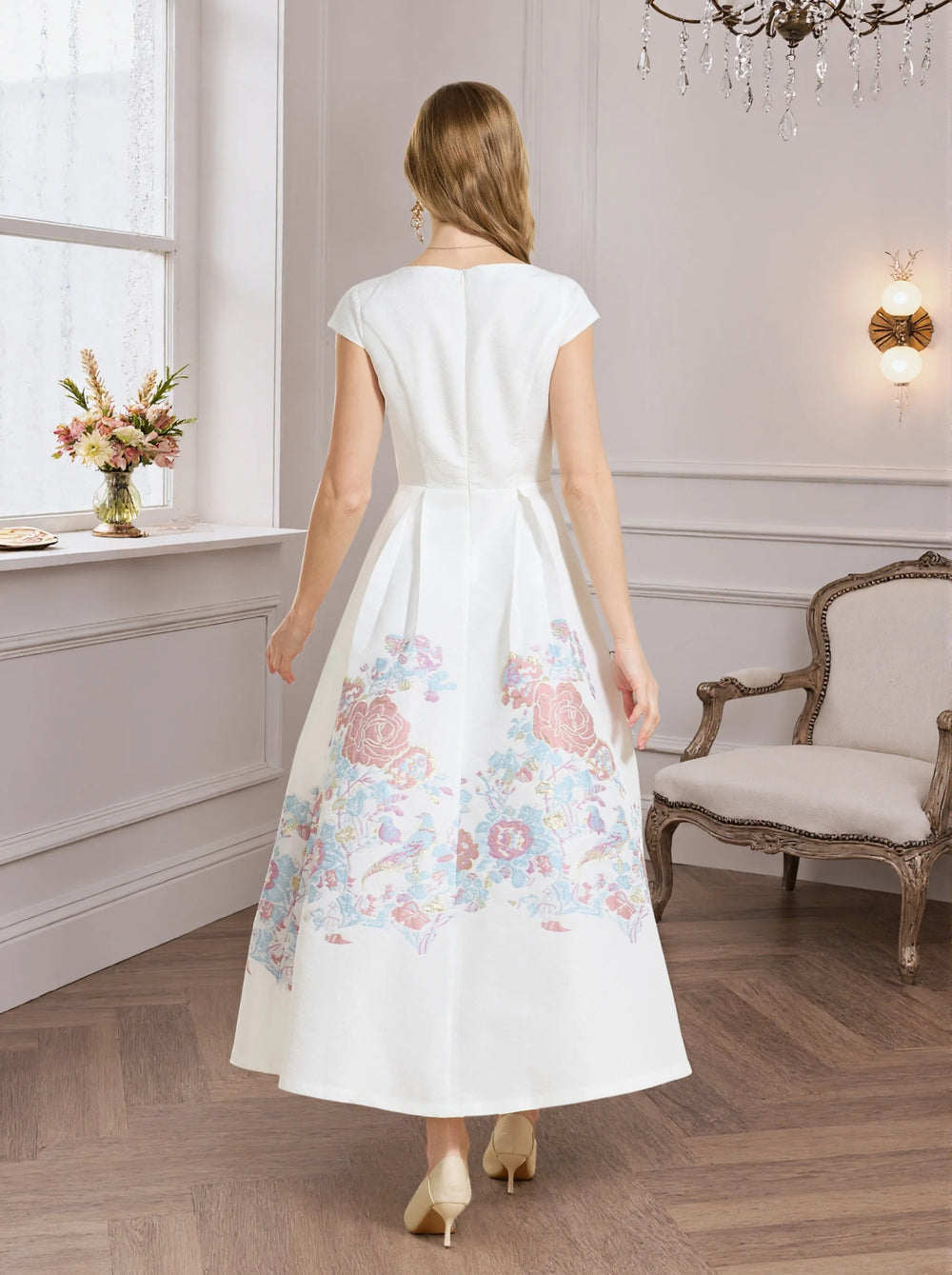 White A-line prom dress back view with pastel floral hem and short sleeves