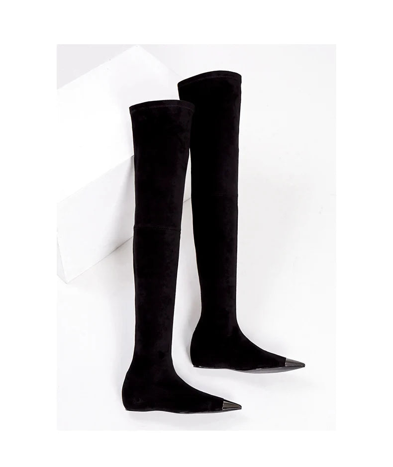 Pair of black thigh-high faux suede boots with pointed toes.