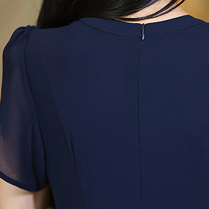 Back of navy evening dress with center back zipper and gathered shoulders