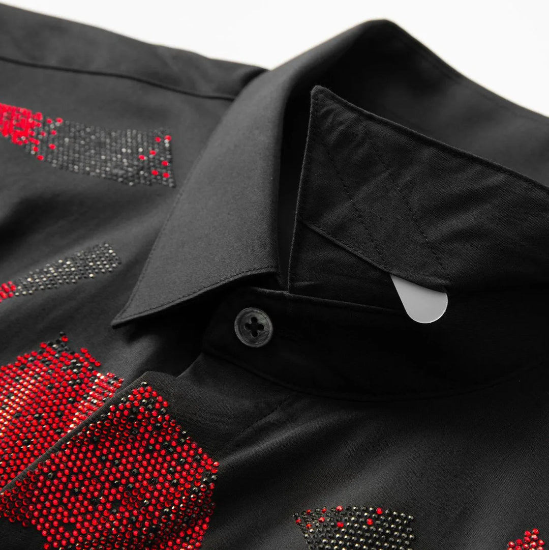 Close-up of black button-up shirt collar with rhinestone red and gray chest details