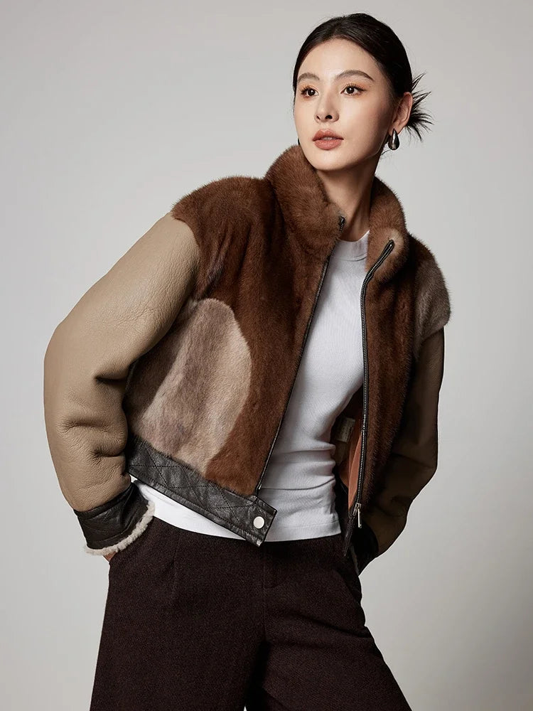 Women’s short mink fur jacket in brown and tan with zip front and leather-trim hem