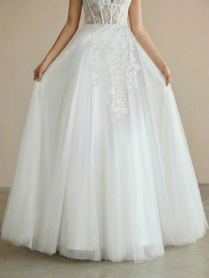 White lace tulle bridal ball gown with fitted lace bodice and full floor-length skirt