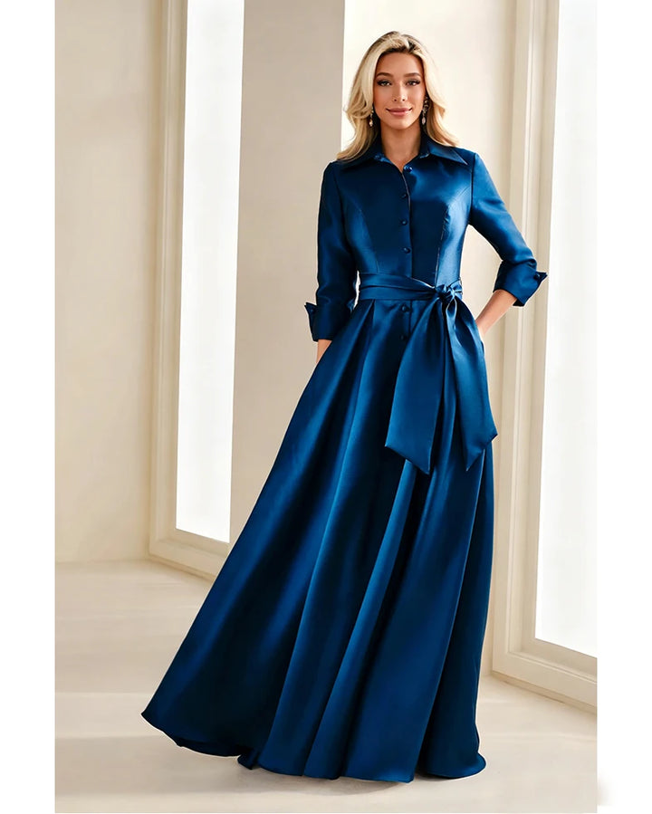 Blue chiffon gown with button front, belted waist tie, long sleeves and full skirt.