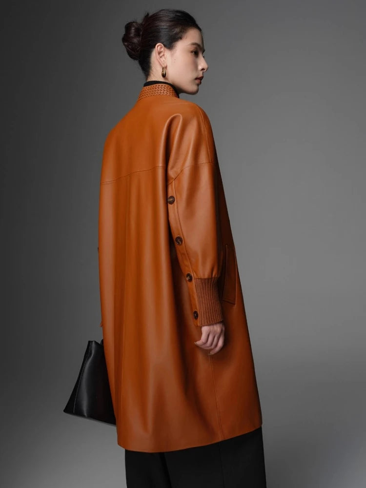 Women’s orange woven coat back view with stand collar and button placket, ribbed knit cuffs