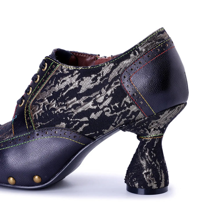 Side view of dark printed leather lace-up heel pump with rivet-studded platform and block heel
