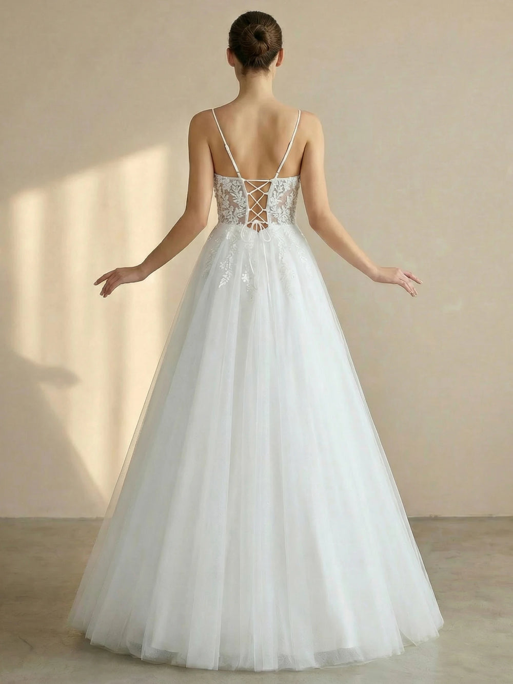 White lace tulle bridal ball gown with open back and crisscross spaghetti straps