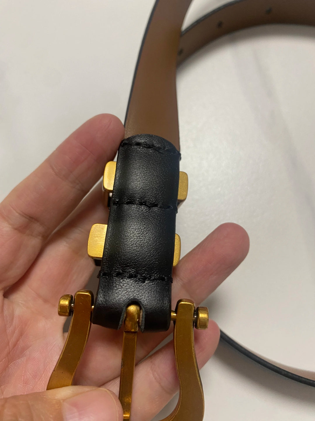Black leather corset belt with gold-tone side grommet and double strap ends