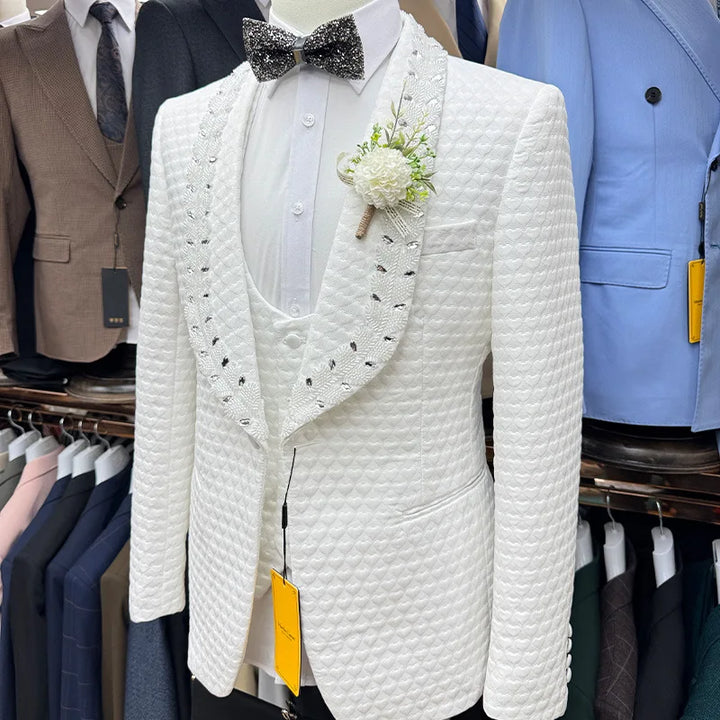 White textured suit jacket with decorative elements on a rack with other suits.