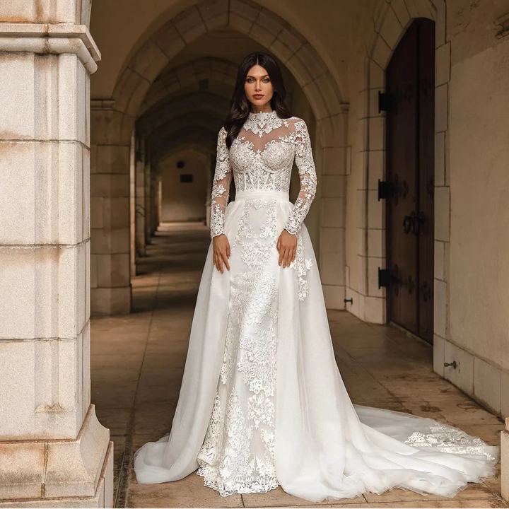 Woman in a white lace wedding dress standing in an architectural setting