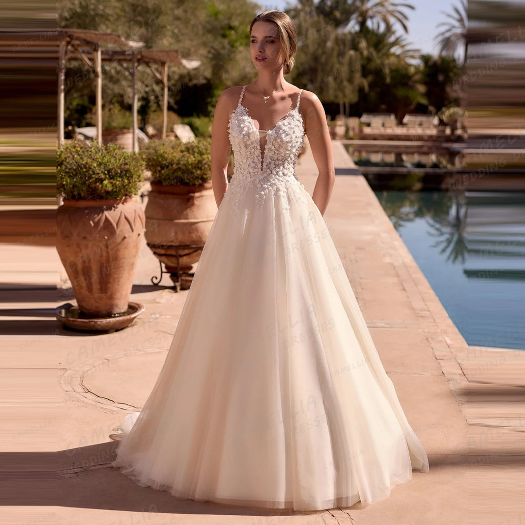 Woman in a white wedding dress standing by a pool with greenery in the background