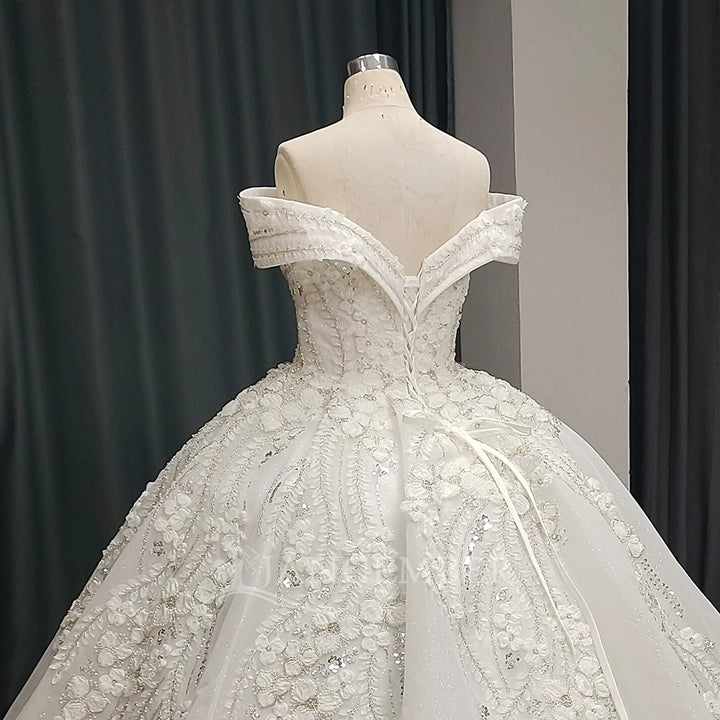 White lace bride dress close-up showing off-shoulder neckline and beaded details