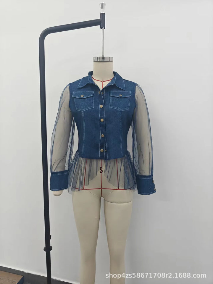 Blue denim patchwork blouse on hanger with sheer sleeves and gathered peplum hem