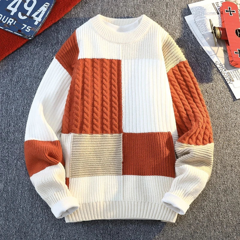 Patchwork knit sweater with white, orange, and beige square panels; ribbed cuffs and hem.