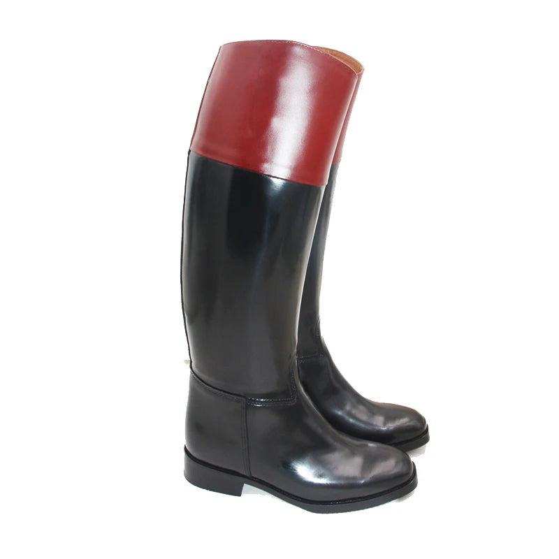 Side view of knee-high riding boots in red upper and black leather, stacked heel.