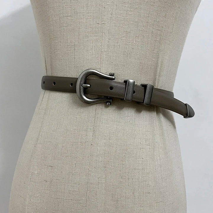 Black narrow leather corset belt with silver-tone oval buckle and two rectangular tabs