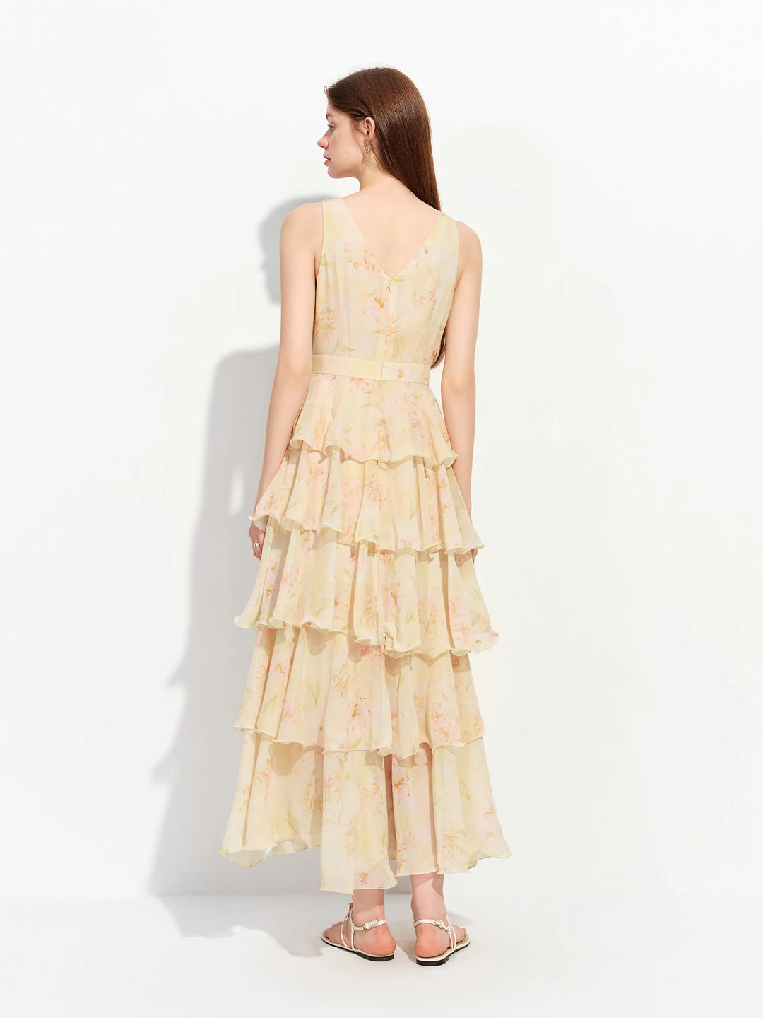 Back view of light yellow floral tiered ruffle maxi dress with open upper back