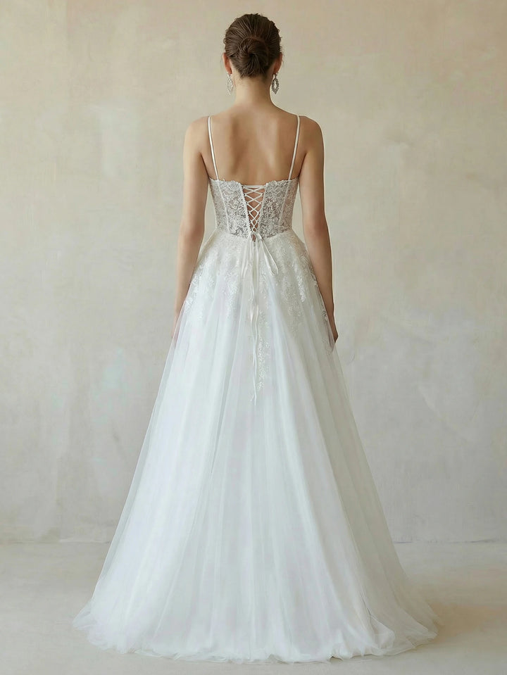 White bridal dress back view with lace bodice and flowing mesh skirt